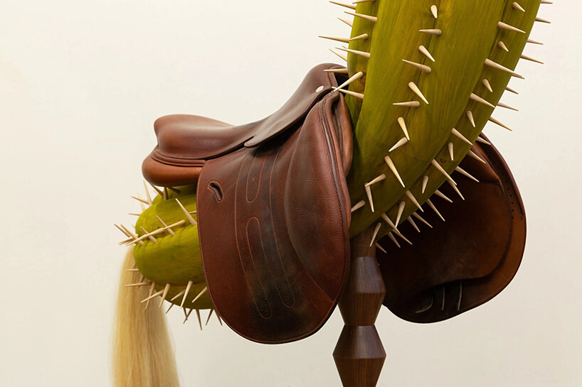 raul de lara carves surreal wooden sculptures to question who gets to belong
