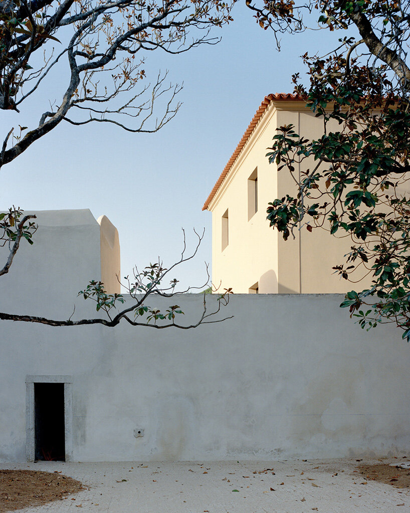 arquitectura-G embeds blue concrete core with spiraling staircase in portuguese residence