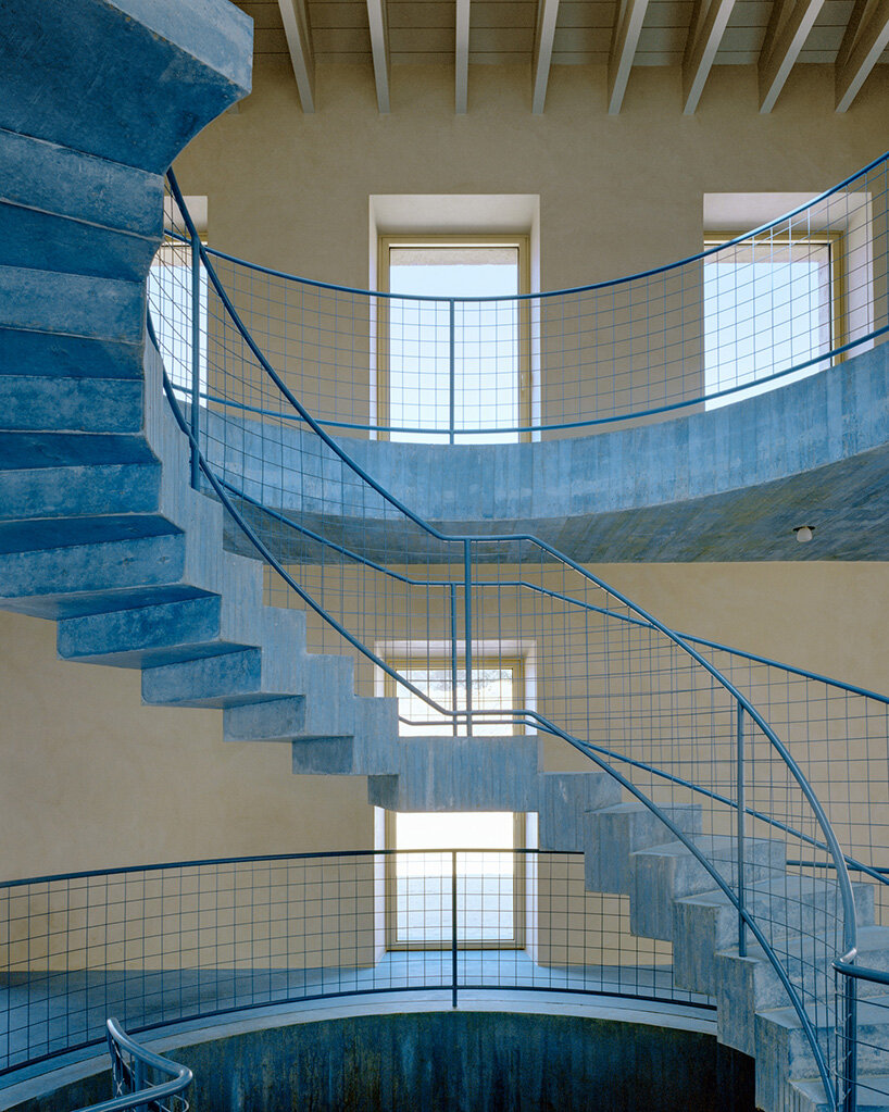 arquitectura-G embeds blue concrete core with spiraling staircase in portuguese residence