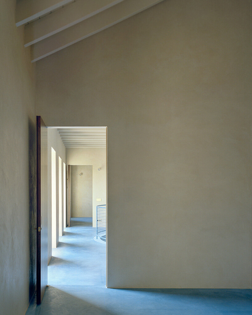 arquitectura-G embeds blue concrete core with spiraling staircase in portuguese residence