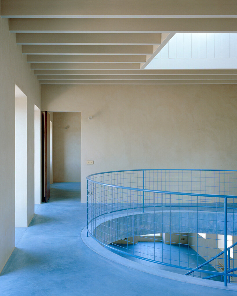 arquitectura-G embeds blue concrete core with spiraling staircase in portuguese residence