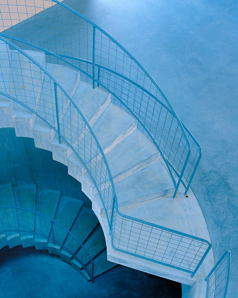 arquitectura-G embeds blue concrete core with spiraling staircase in portuguese residence