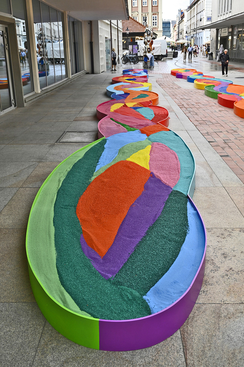 tons of colored aggregates mix together to form color path public art installation in poland