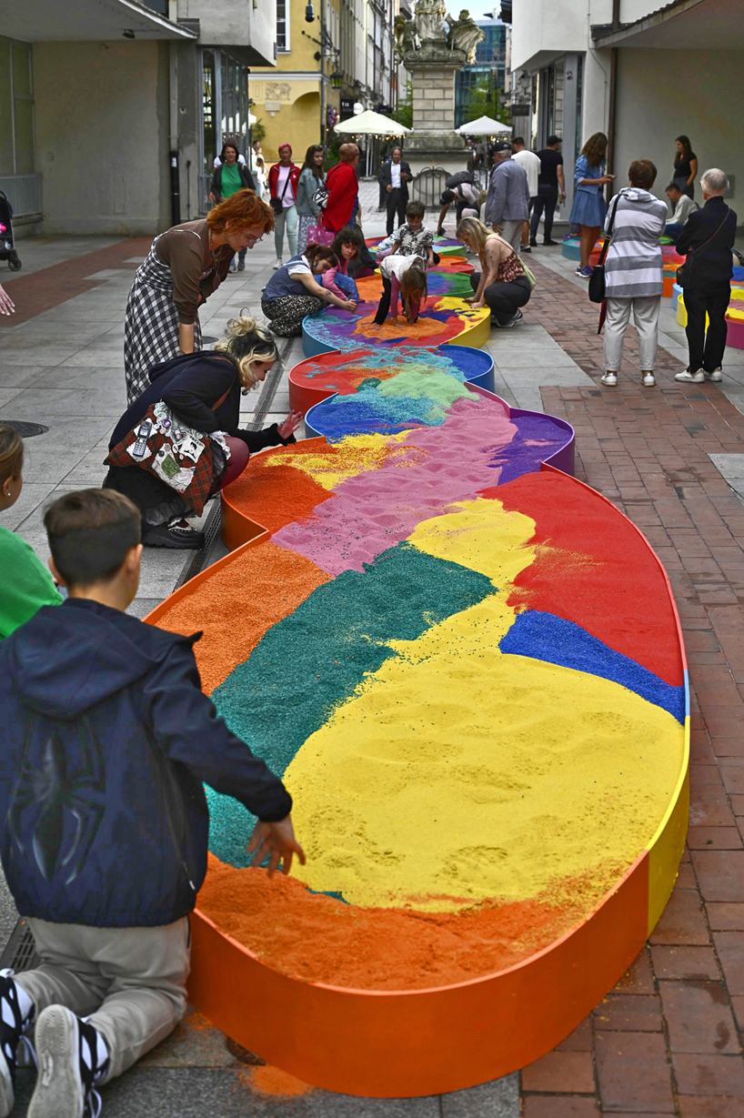 tons of colored aggregates mix together to form color path public art installation in poland