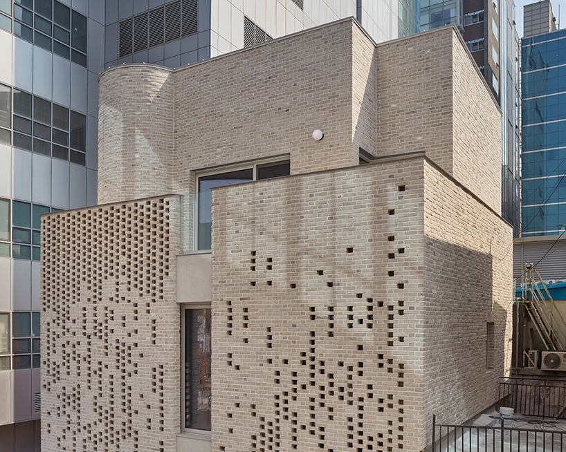 perforated brickwork forms pixelated pattern upon restored seoul building by NOMAL