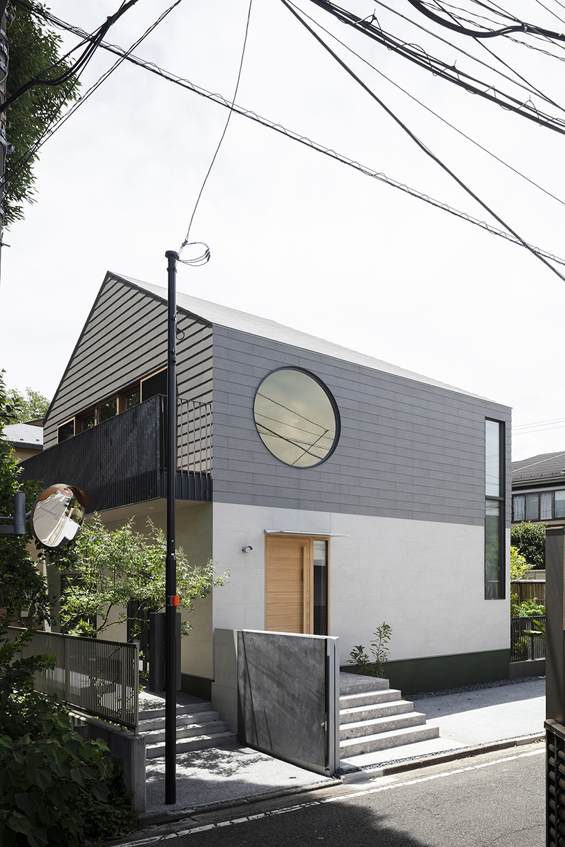 circular aperture welcomes natural light within gabled tokyo house by KIAS