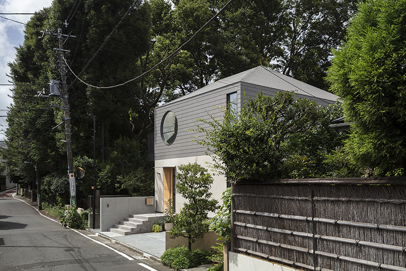 circular aperture welcomes natural light within gabled tokyo house by KIAS