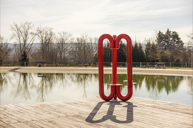 three-legged installation turns industrial gas pipes into intimate public shelter