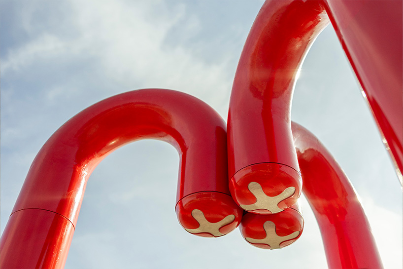 three-legged installation turns industrial gas pipes into intimate public shelter