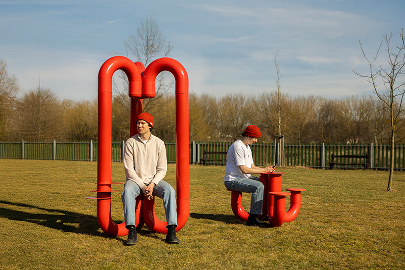 three-legged installation turns industrial gas pipes into intimate public shelter